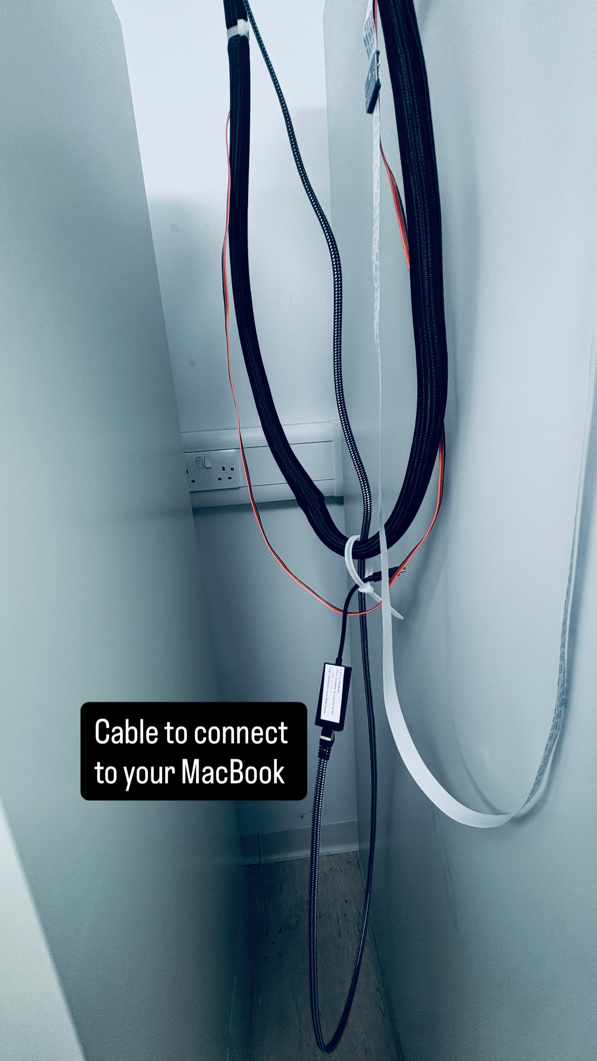 Ethernet cable hanging on the wall beside TSL PGC07, labelled "Cable to connect to your MacBook"