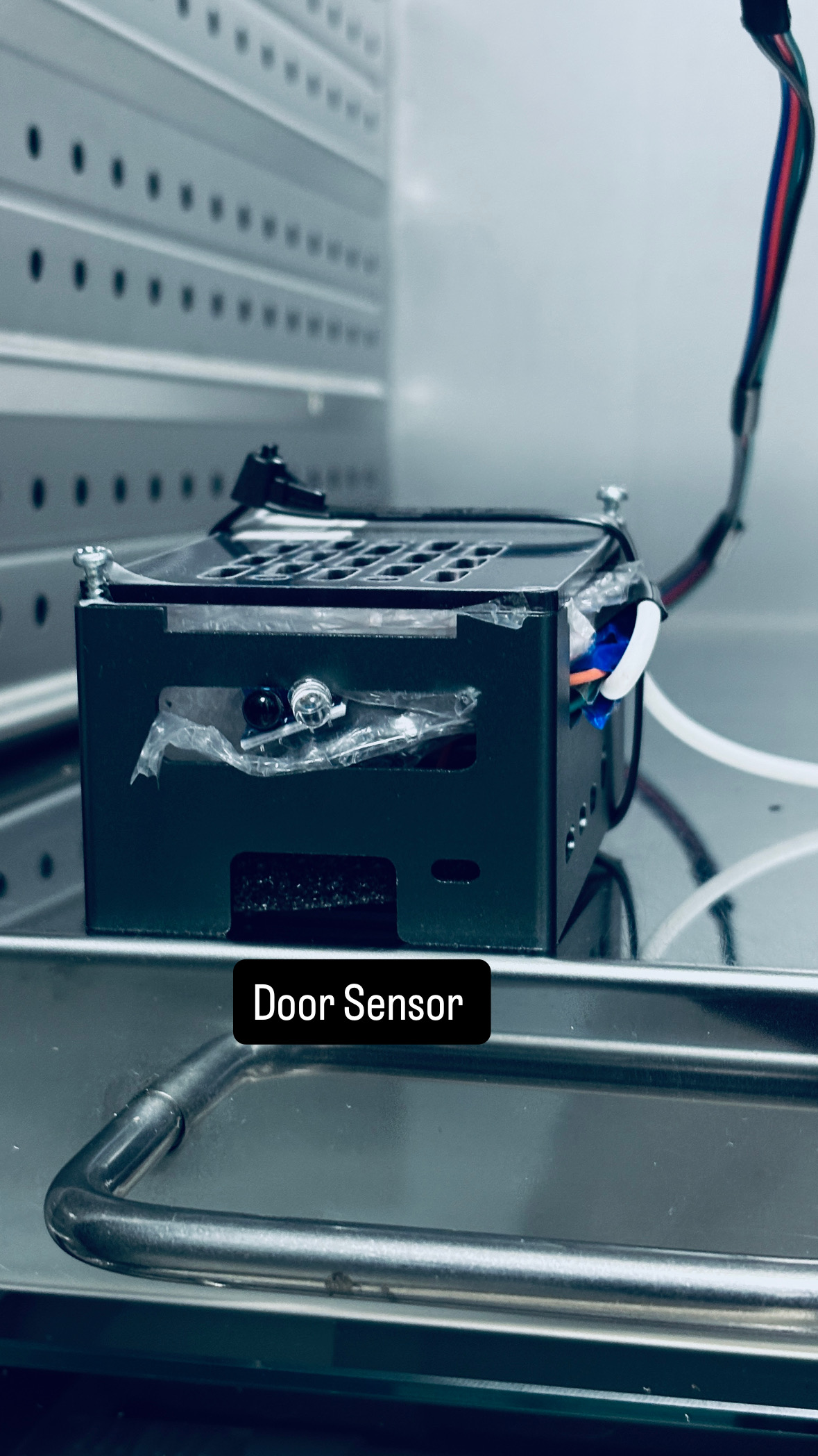 Door sensor (interlock) showing green active state, and the AC-side emergency stop switch